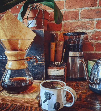 Coffee brewing equipment and a mug on the brick-wall counter in the original Spacesicle.