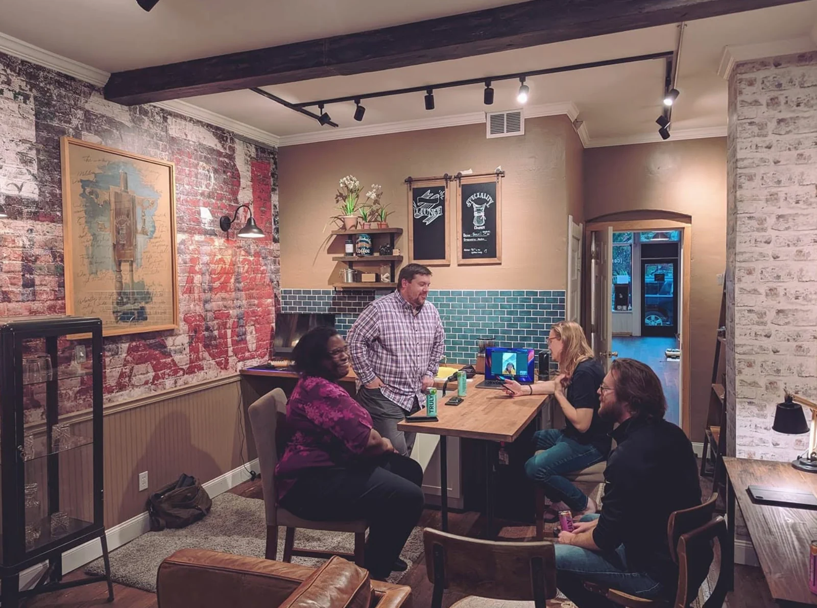 People meeting around a wooden table inside Spacesicle