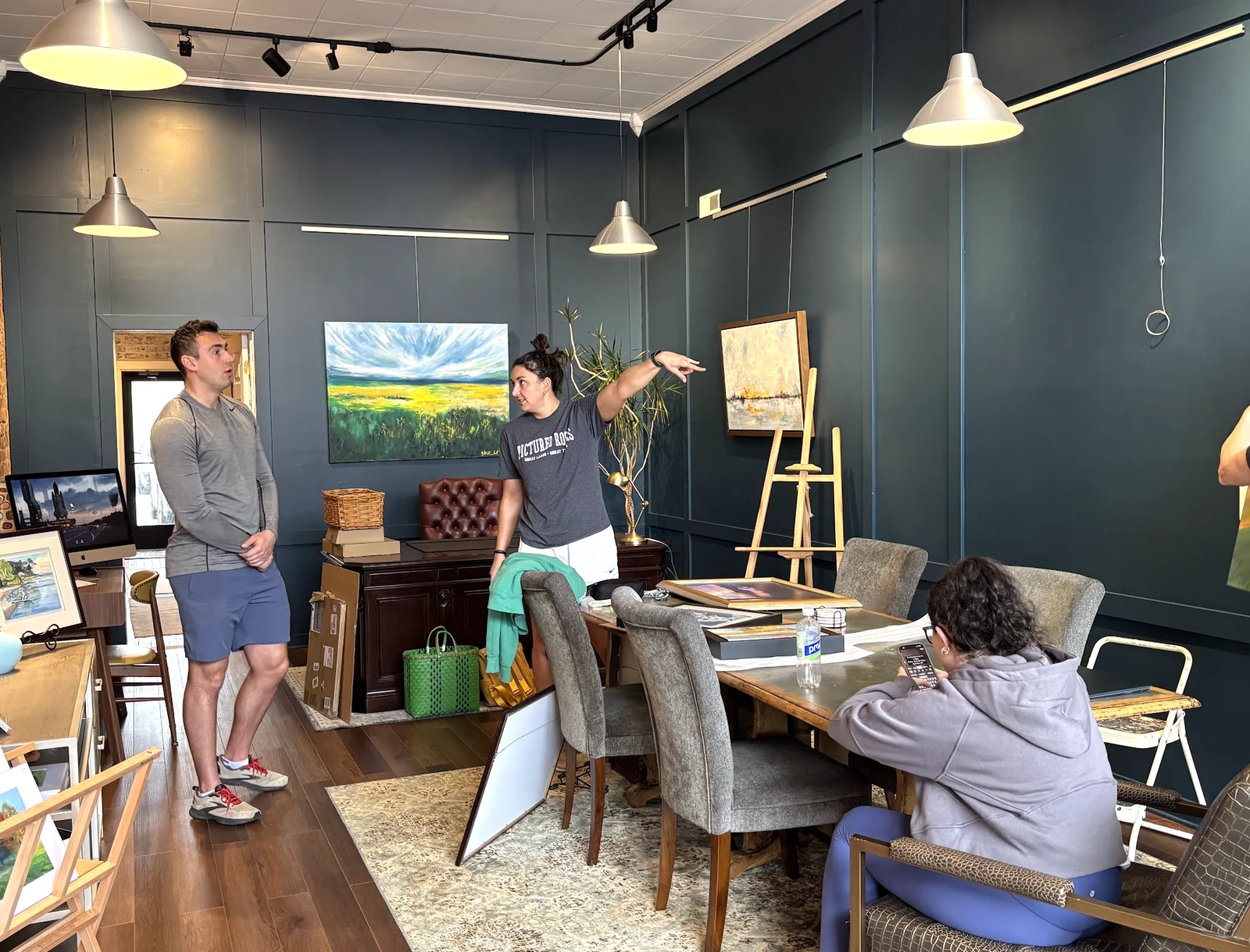 An artist displaying paintings at Spacesicle during Redbird